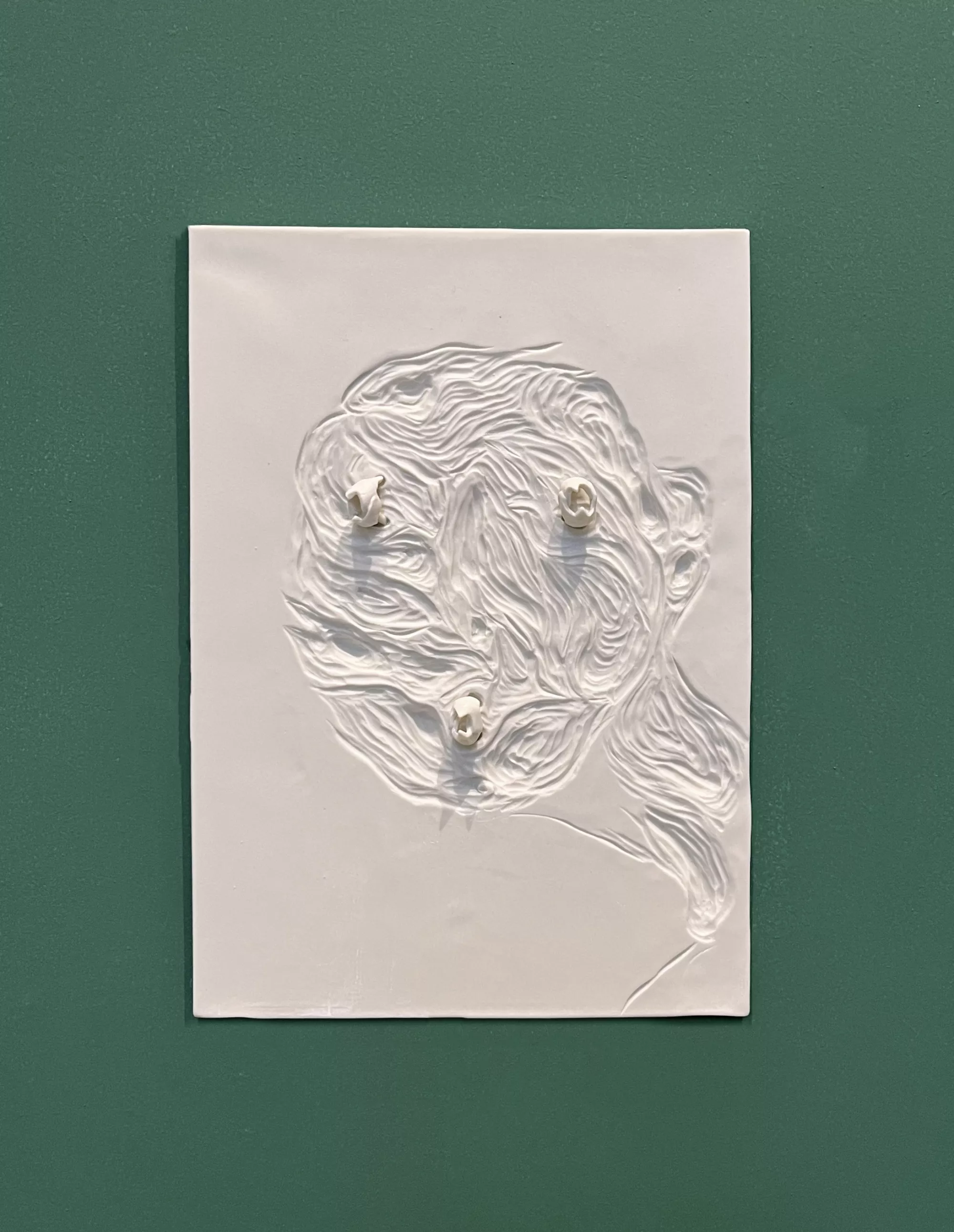 Gaia Fugazza - Gaia Fugazza, Beaks, 2024, Porcelain bas-relief depicting a face made of water with octopus beaks as the eyes and mouth.