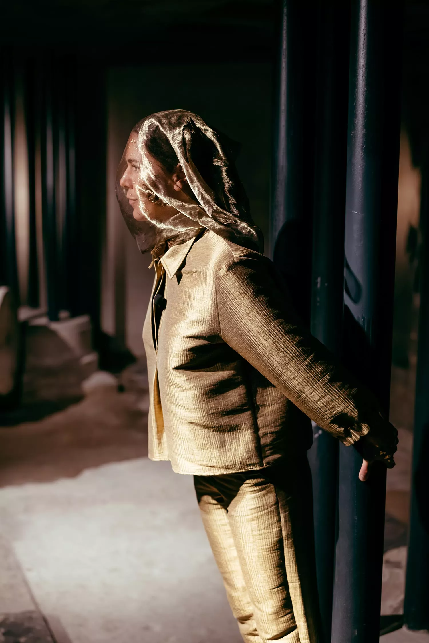 Gaia Fugazza - Gaia Fugazza, 2024, Farewell to Known Skies. A performer is dressed in a gold suit and a sheer face covering. 